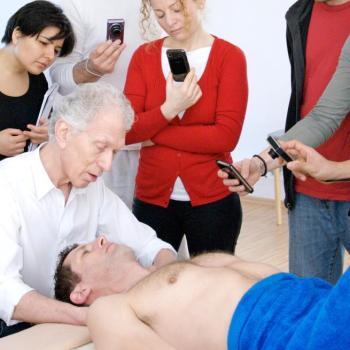 Harvey Burns in class demonstrating a Rolfing technique to students