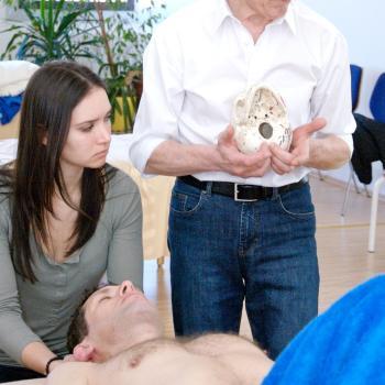 Harvey Burns in class demonstrating a Rolfing technique to students